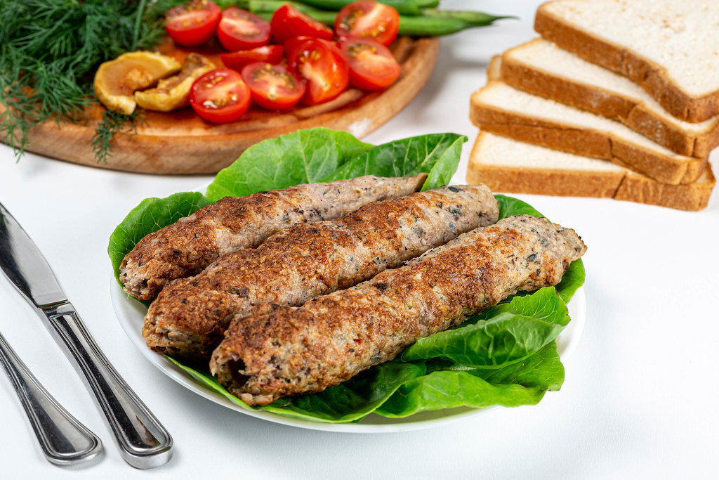 Grilled Lulia Kebab with fresh leaves of romaine lettuce