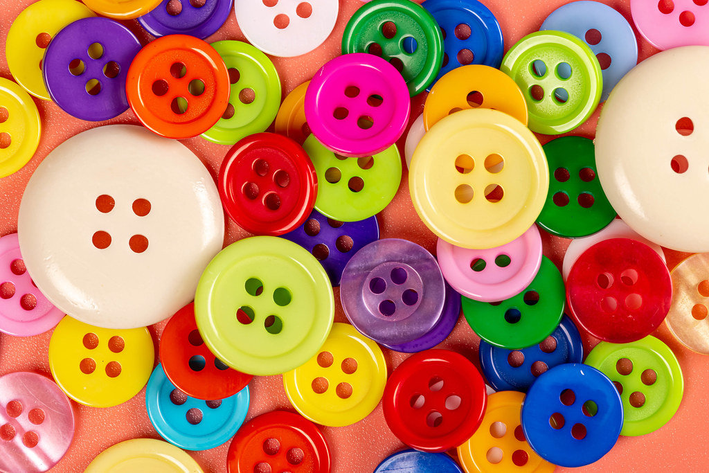 Bright multicolored buttons background, top view