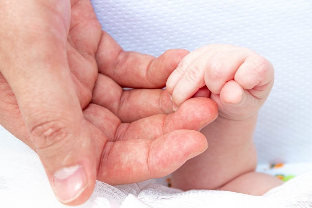 Big mans hand and little hand newborn (Flip 2019)