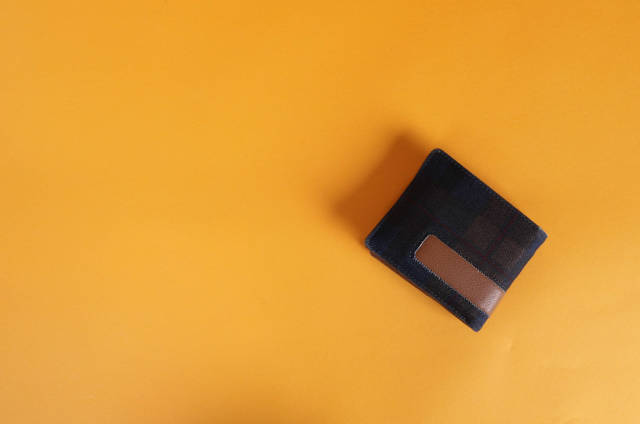 Wallet on orange background with copy space