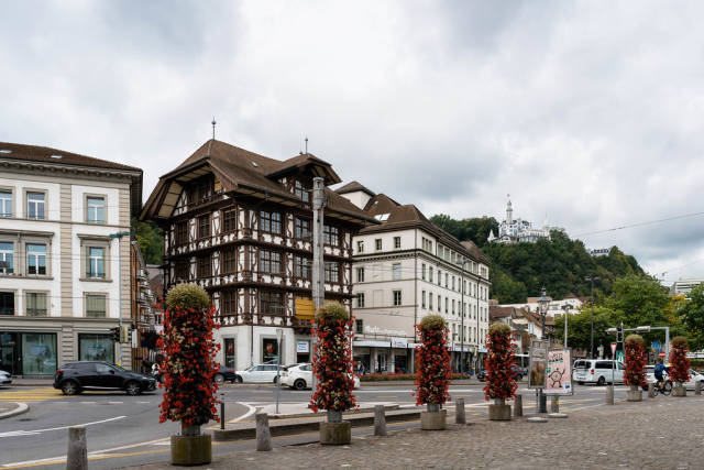 City street of Lucerne, Switzerland with authentic old architecture and castle on top of the hill