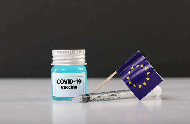 EU flag with syringe and Covid-19 vaccine