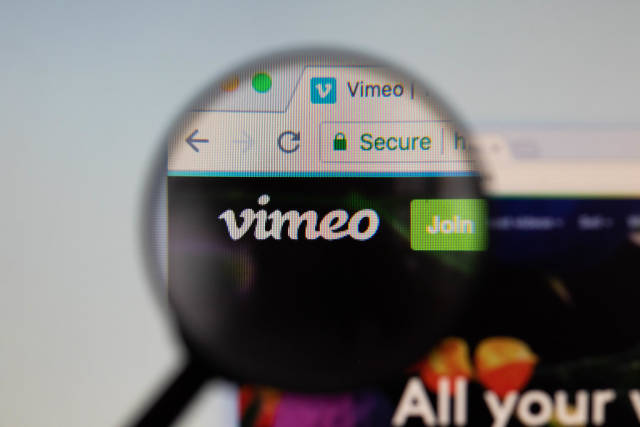 Vimeo logo on a computer screen with a magnifying glass