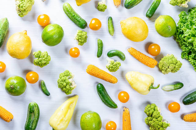 Top view fresh vegetables and fruits on white wooden background