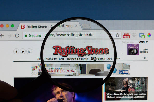 Rolling Stone logo on a computer screen with a magnifying glass