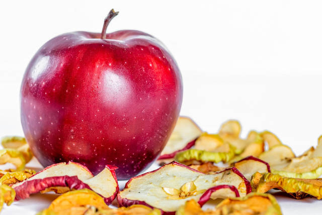 Beautiful red Apple on the background with dried apples