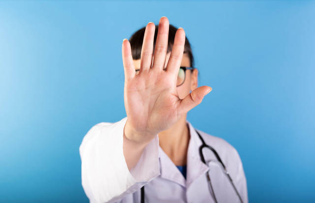 Doctor showing stop gesture