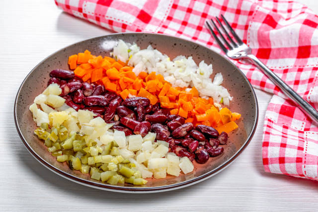 Healthy lunch with boiled vegetables and pickles with onions
