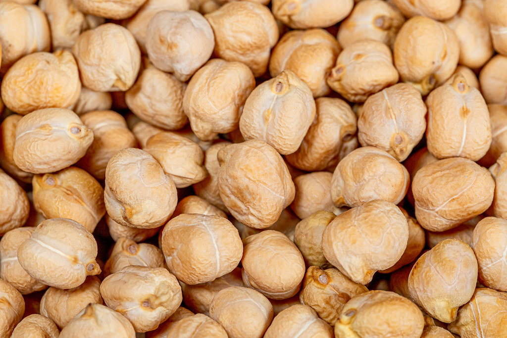 Dry raw chickpeas background. Top view