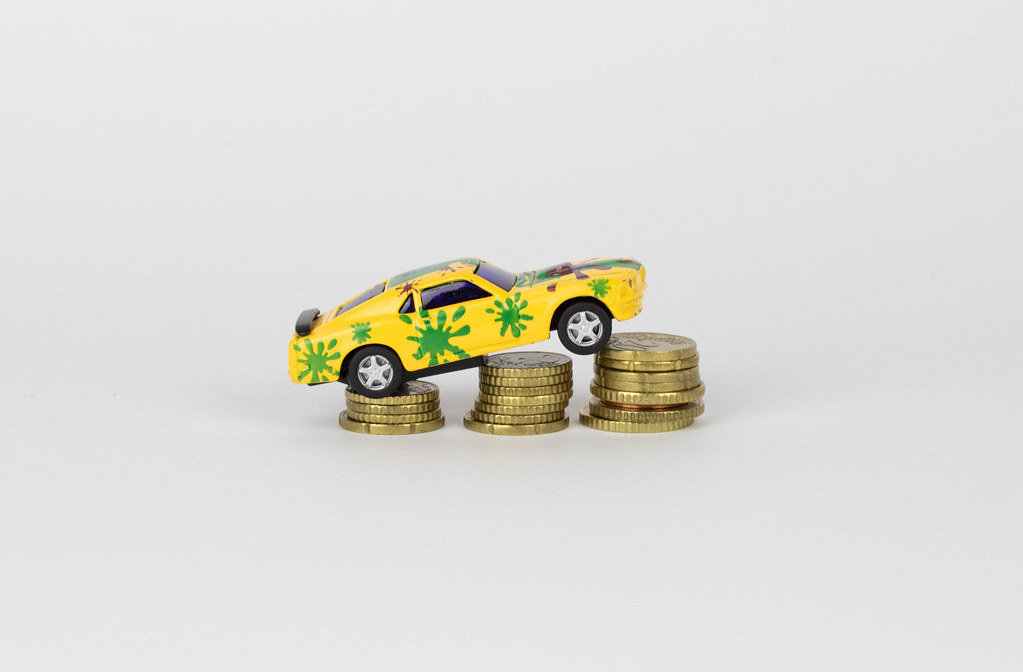 Toy car on coin stack