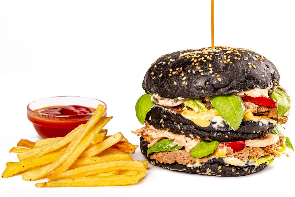 Black burger with french fries