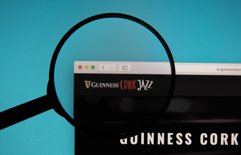 Guinness Jazz Festival logo on a computer screen with a magnifying glass