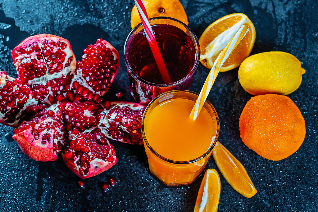 Fresh pomegranate and orange juice with ripe fruit