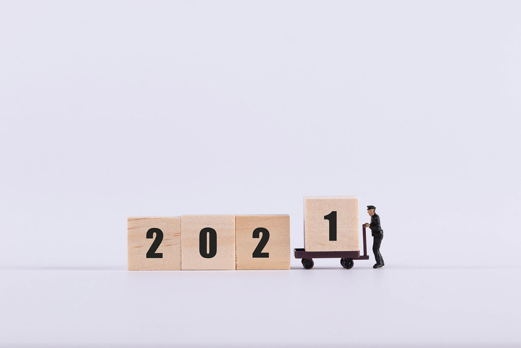 Delivery man adding 1 to 2021 text