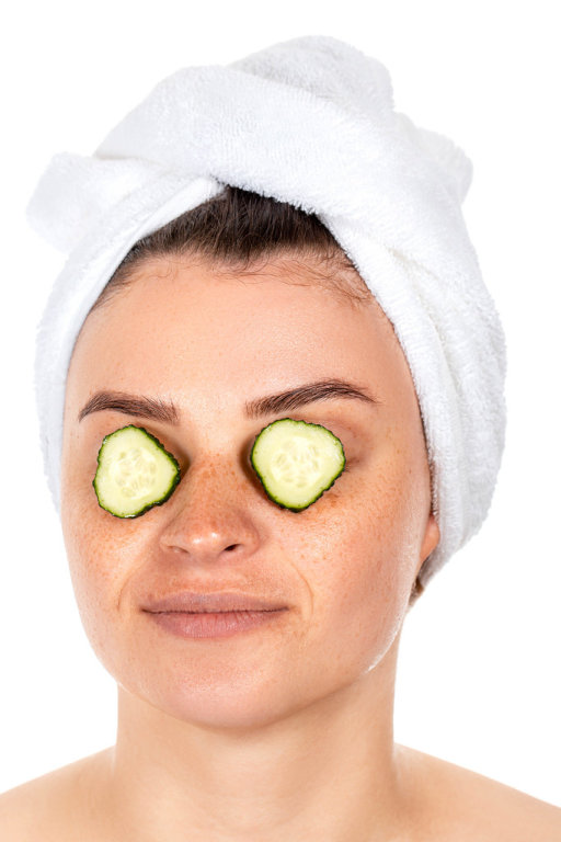 Girl with slices of fresh cucumber on her eyes. The concept of caring for your appearance