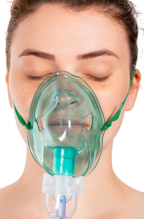 Close up of a girl with a mask for inhalation on her face