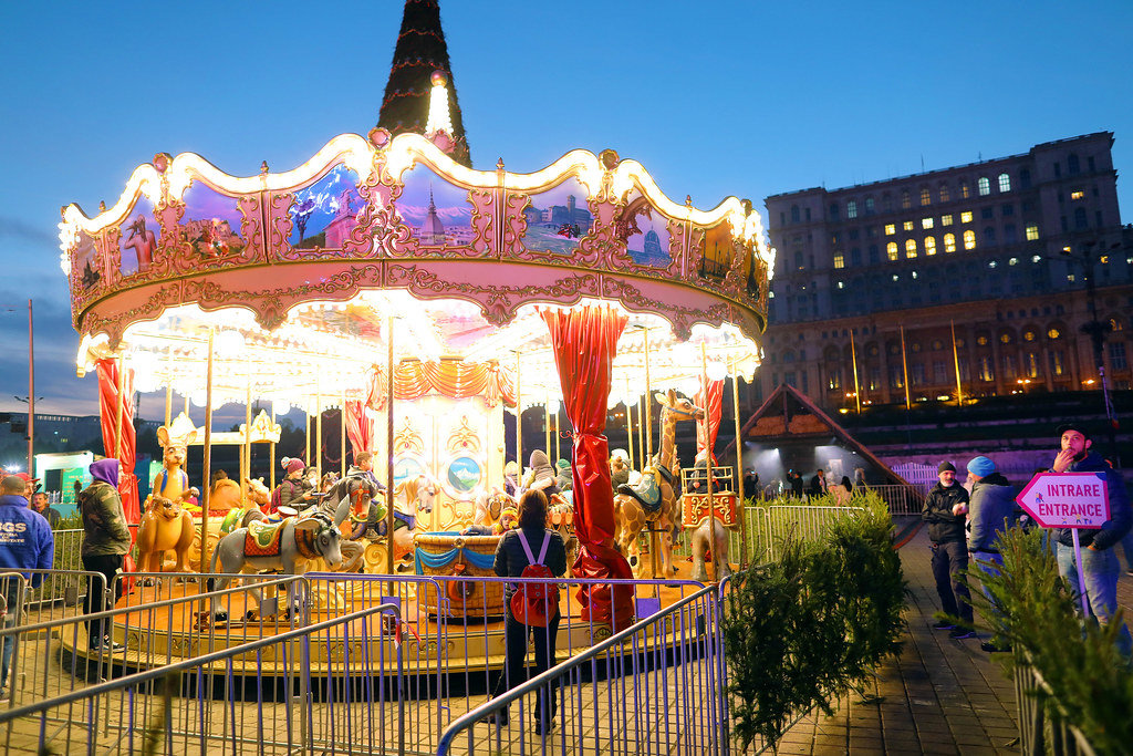 Carousel at Bucharest Christmas Market, The Palace of Parliament on background