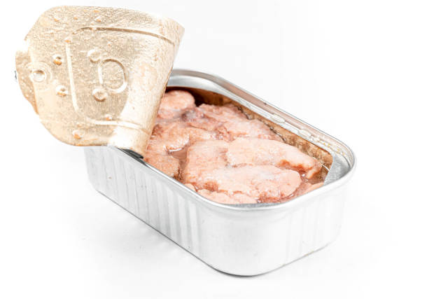 Open canned cod liver on a white background
