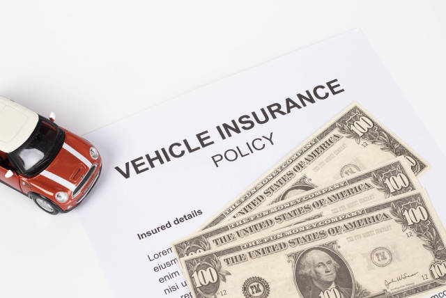 Vehicle Insurance Policy with red toy car