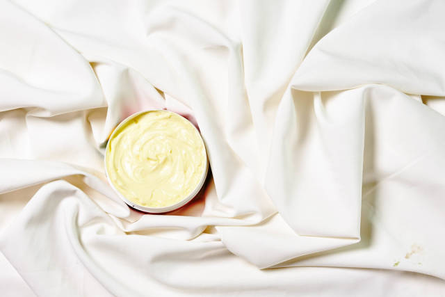 Face cream moisturizer for sensitive skin on white silk fabric