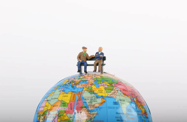 Elderly people sitting on globe