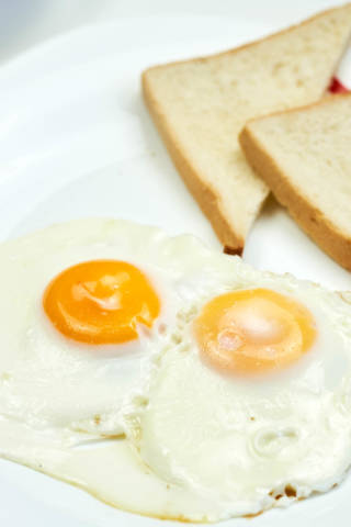 Close-up view of toasts with fried eggs