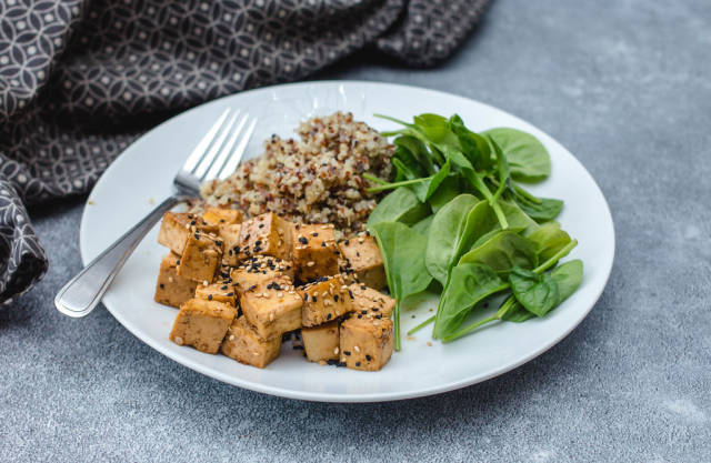 tofu and quinoa with spinach in a plate