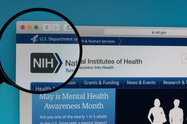 National Institutes of Health logo under magnifying glass