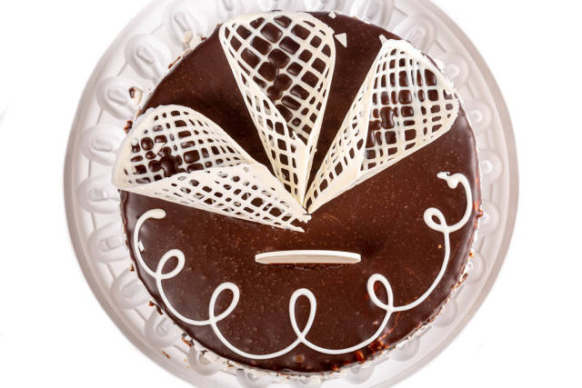 Top view, birthday chocolate cake with white chocolate decor