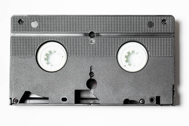 Old film videocassette on a white background