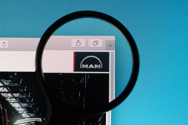 MAN logo under magnifying glass