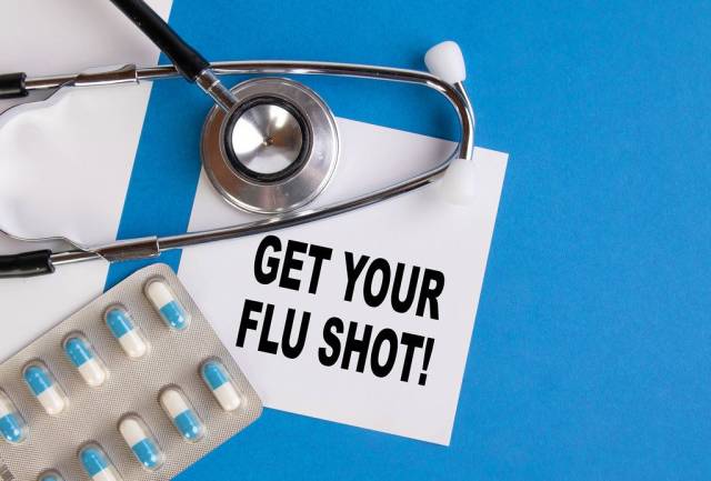 Get your flu shoot written on medical blue folder