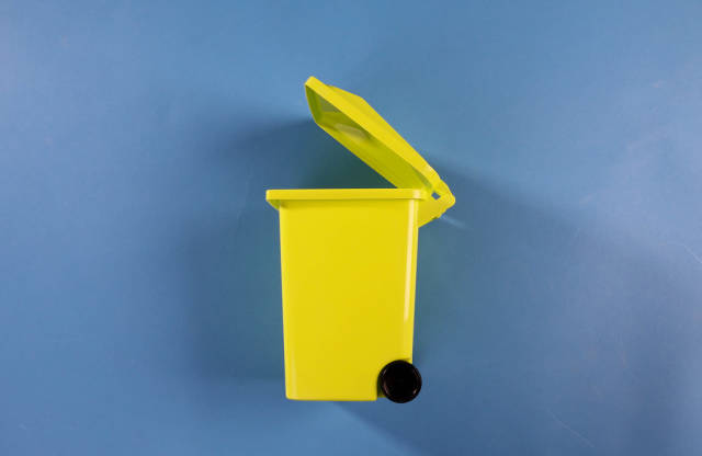 A garbage can on blue background