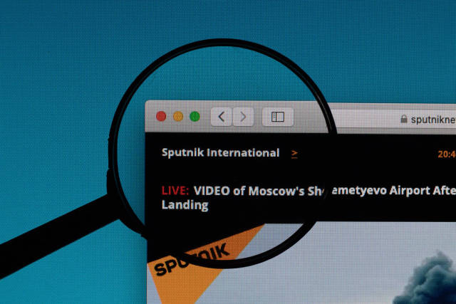 Sputnik International logo under magnifying glass