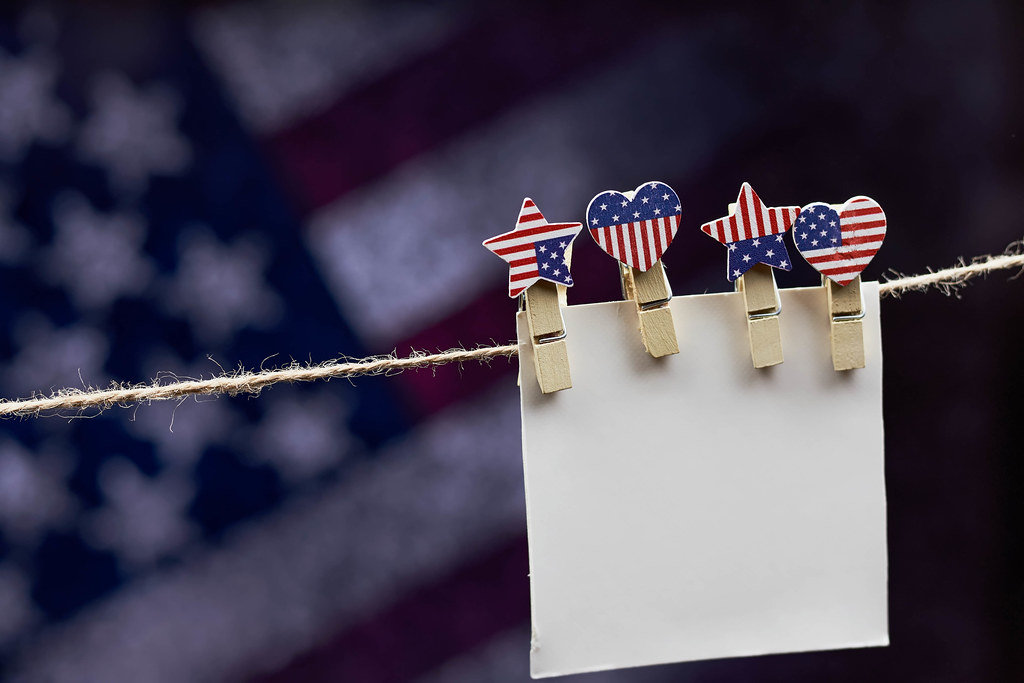 An empty paper card hanged with clothespin on the rope