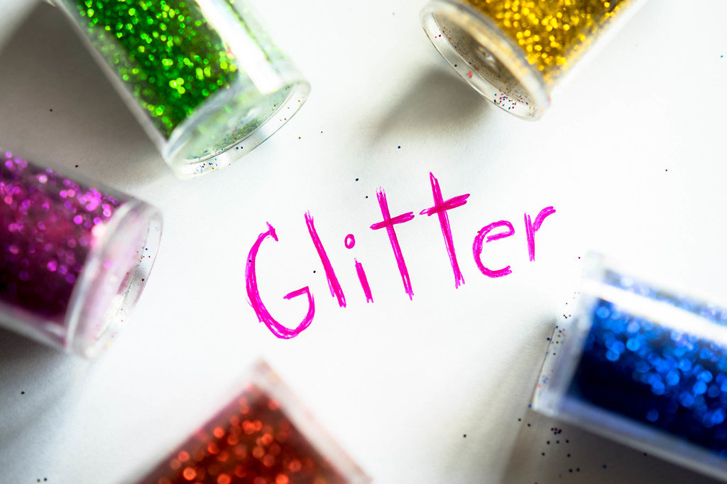 GLITTER word with glitter bottles around it