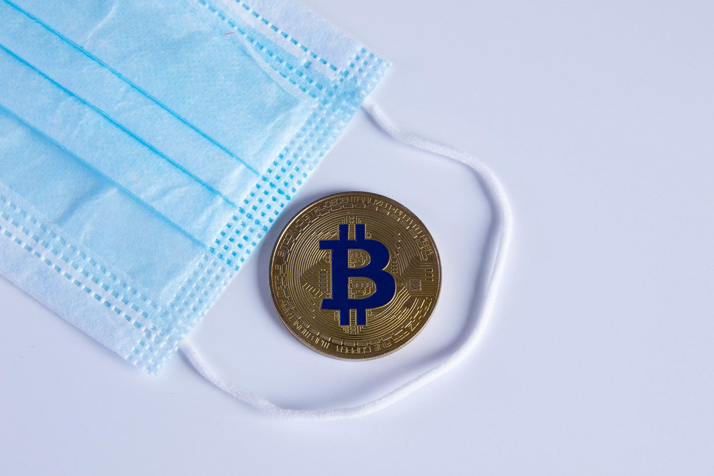 Golden Bitcoin with protective face mask