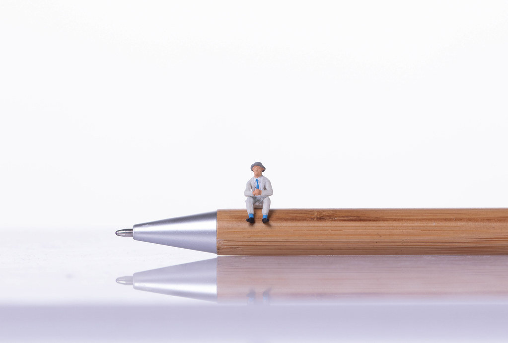 Man sitting on a wooden pen
