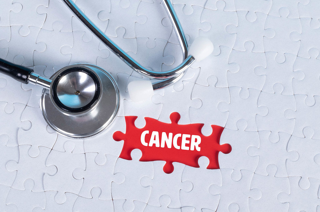 Stethoscope and missing puzzle with a Cancer text