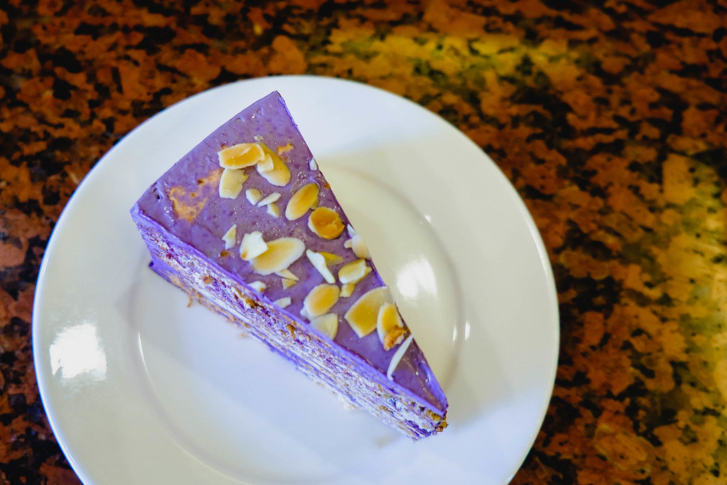 Ube cake with nuts on flat surface