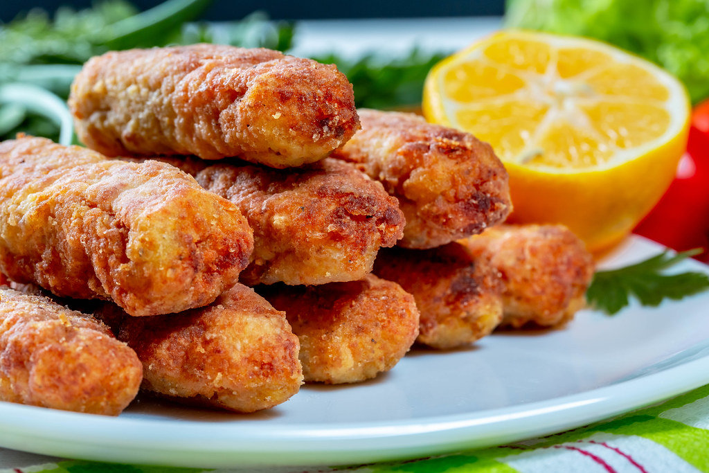 Fish cutlets fried on a plate with lemon