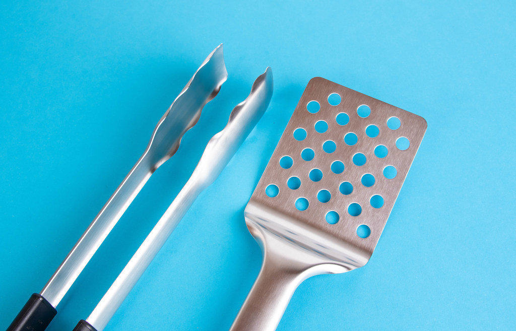 Barbecue tools on blue background
