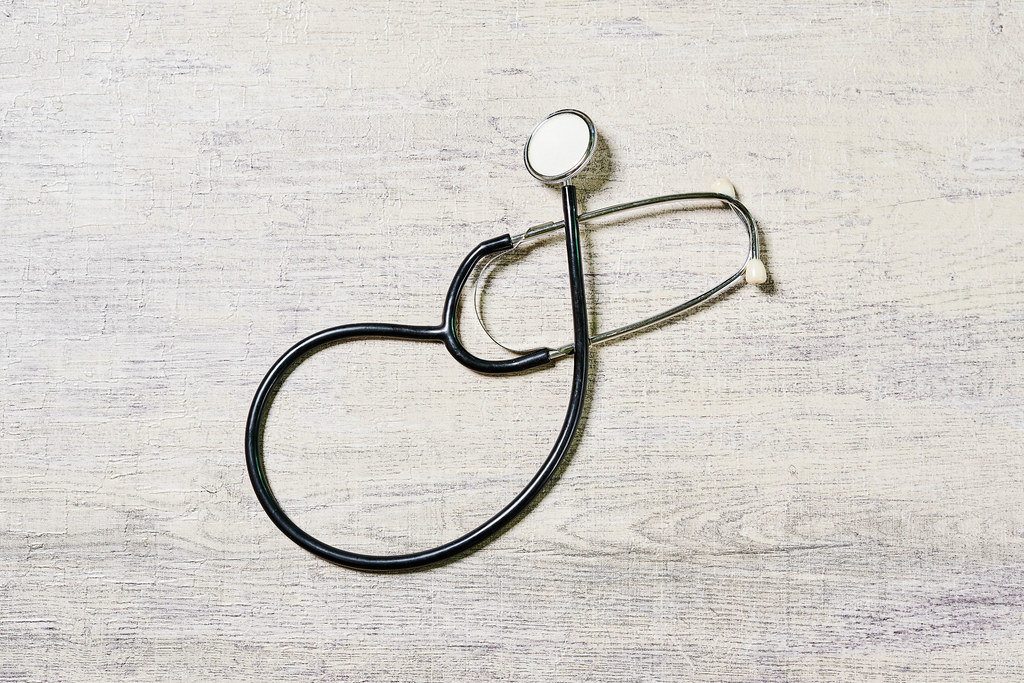 A stethoscope on a bright wooden table