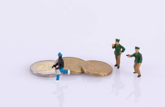 Thief and police with coins on white background