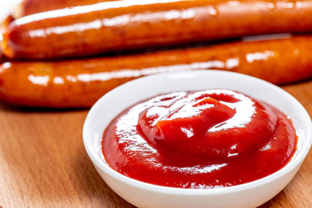 Fried sausages with tomato sauce close-up