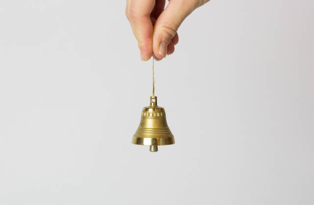 Hand holding bell