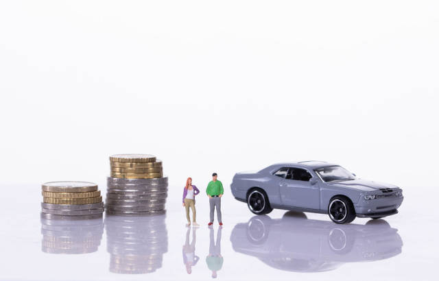 Couple with coin stacks and sports car on white background