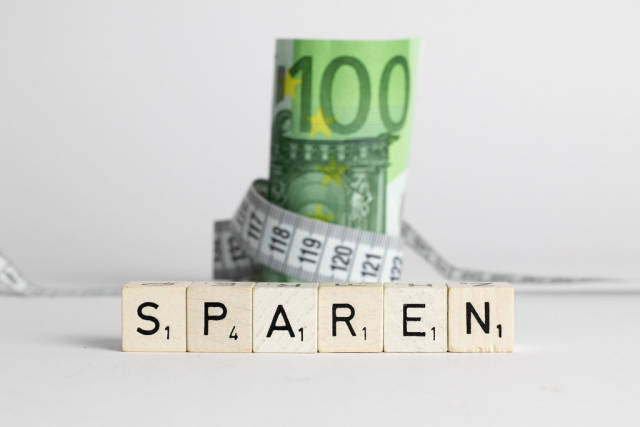 Euro banknote with measure tape and German word Sparen