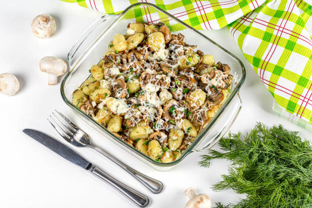 Ready-made potato gnocchi in a glass pan with mushrooms and mozzarella