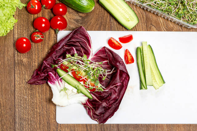 Salad chicory radicchio with cheese, vegetables and radish micro greens